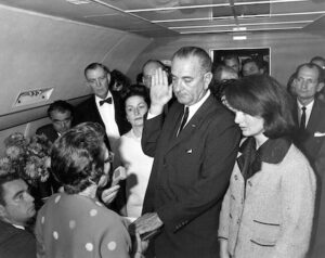 Judge Sarah T. Hughes administers the Presidential Oath of Office to Lyndon Baines Johnson around 2:40 p.m. (CT) aboard Air Force One at Love Field in Dallas. Mrs. Johnson, Mrs. Kennedy, Jack Valenti, Rep. Albert Thomas, Rep. Jack Brooks, Associate Press Secretary Malcolm Kilduff (holding microphone) and others witness the oath. (Cecil Stoughton/John F. Kennedy Library and Museum/MCT) ORG XMIT: